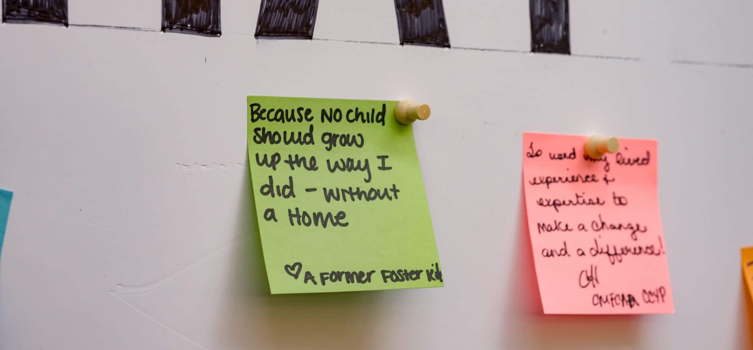Sticky notes with powerful messages about adoption advocacy stuck to a wall.