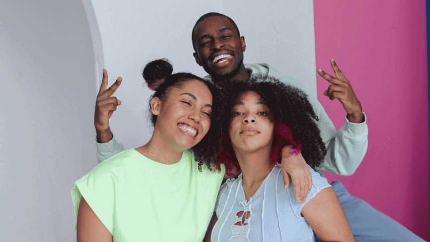 Teens smiling at the camera and being silly.
