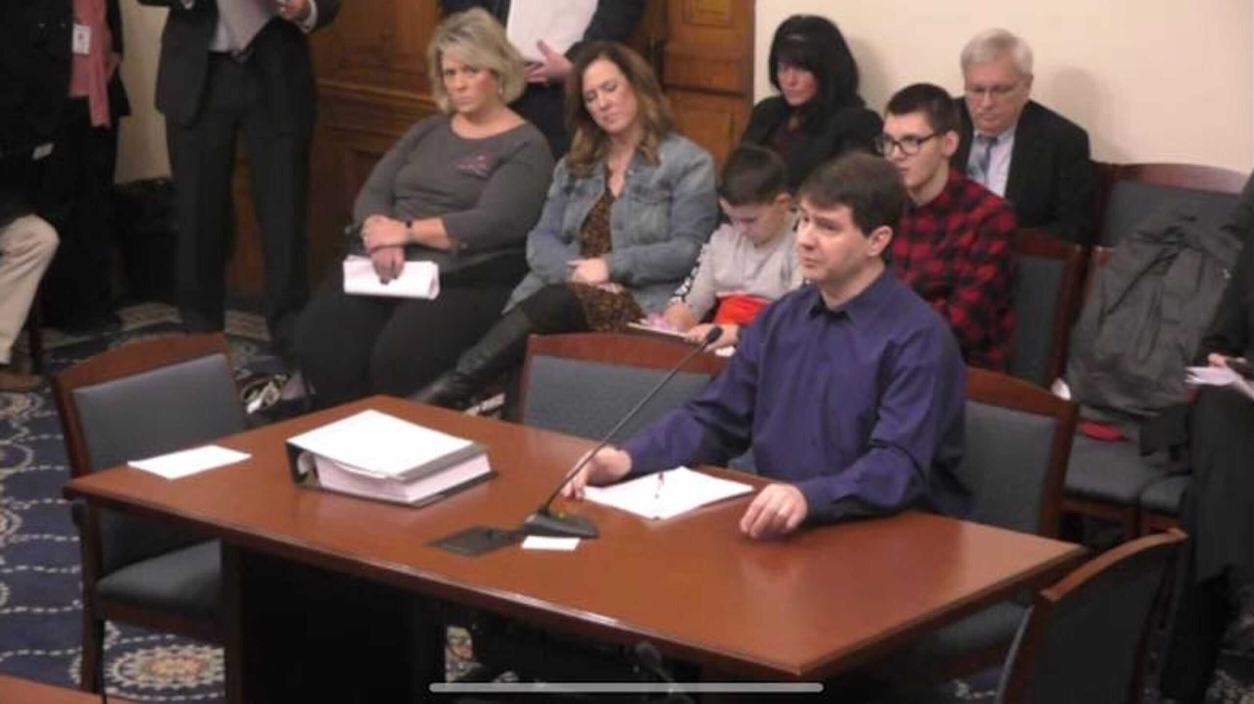 2019 Indiana Senate Testimony Josh Kroll testifying in a courtroom with multiple people sitting behind him